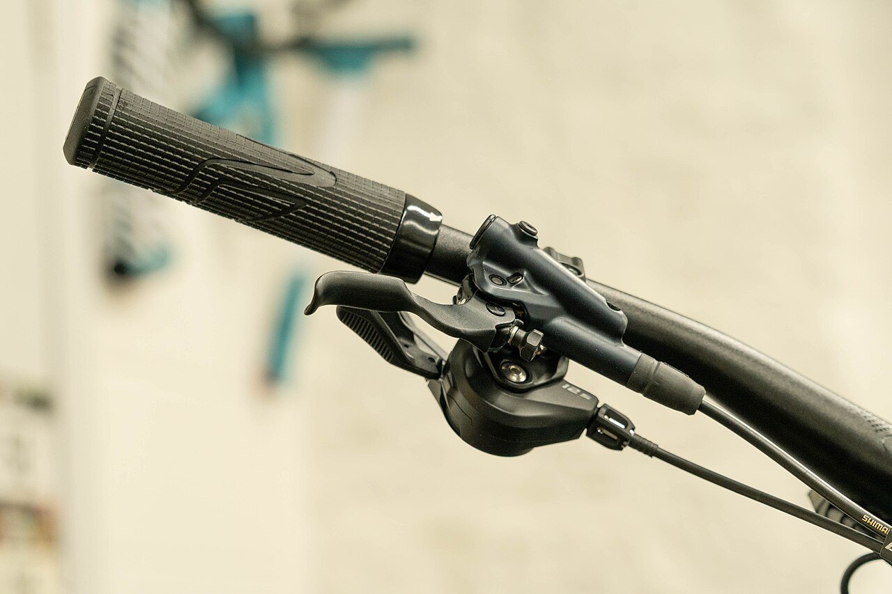 Brake and gear levers on a bicycle handlebar.