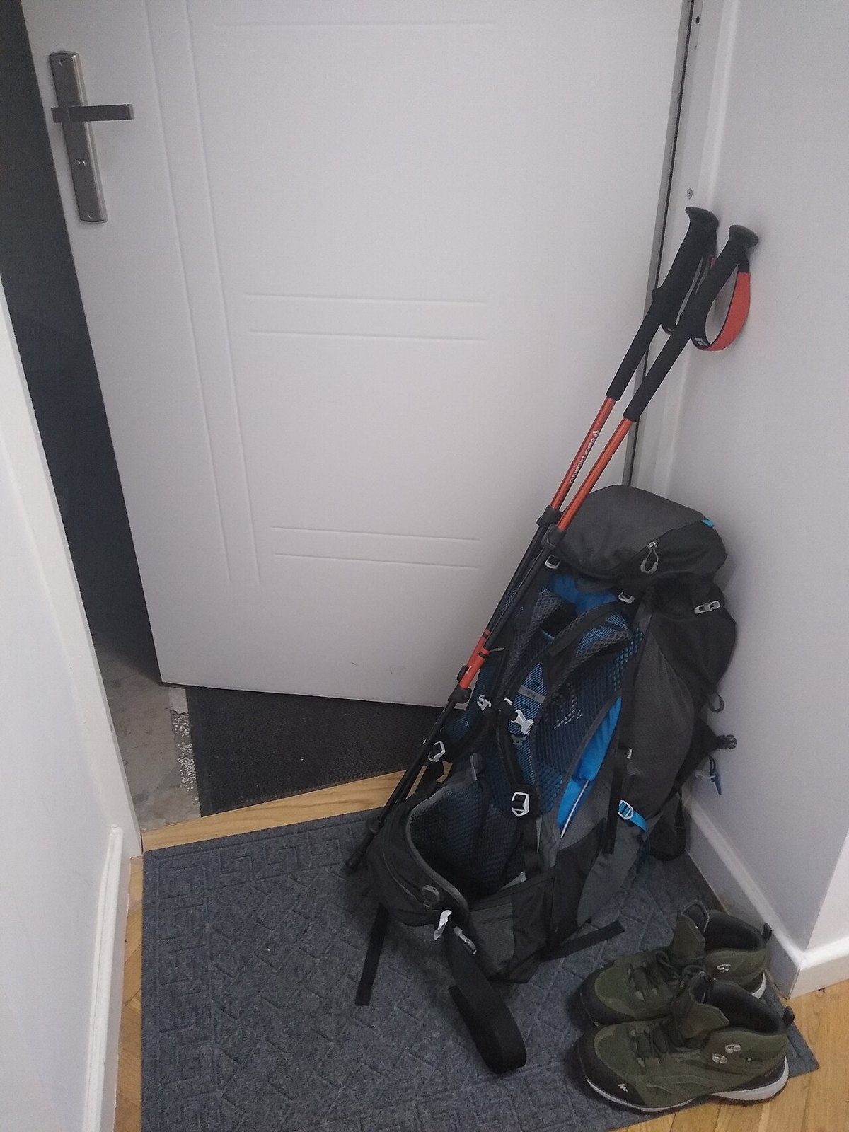 A backpack, poles and shoes as examples of day-trip equipment.