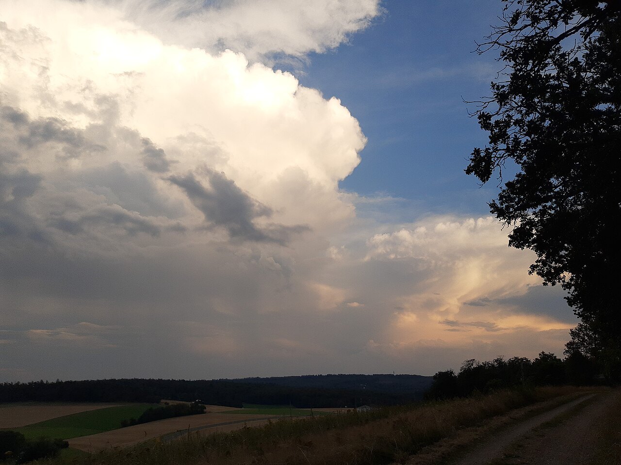 Storm clouds over fields near Eschenhahn, illustrating a change in weather.